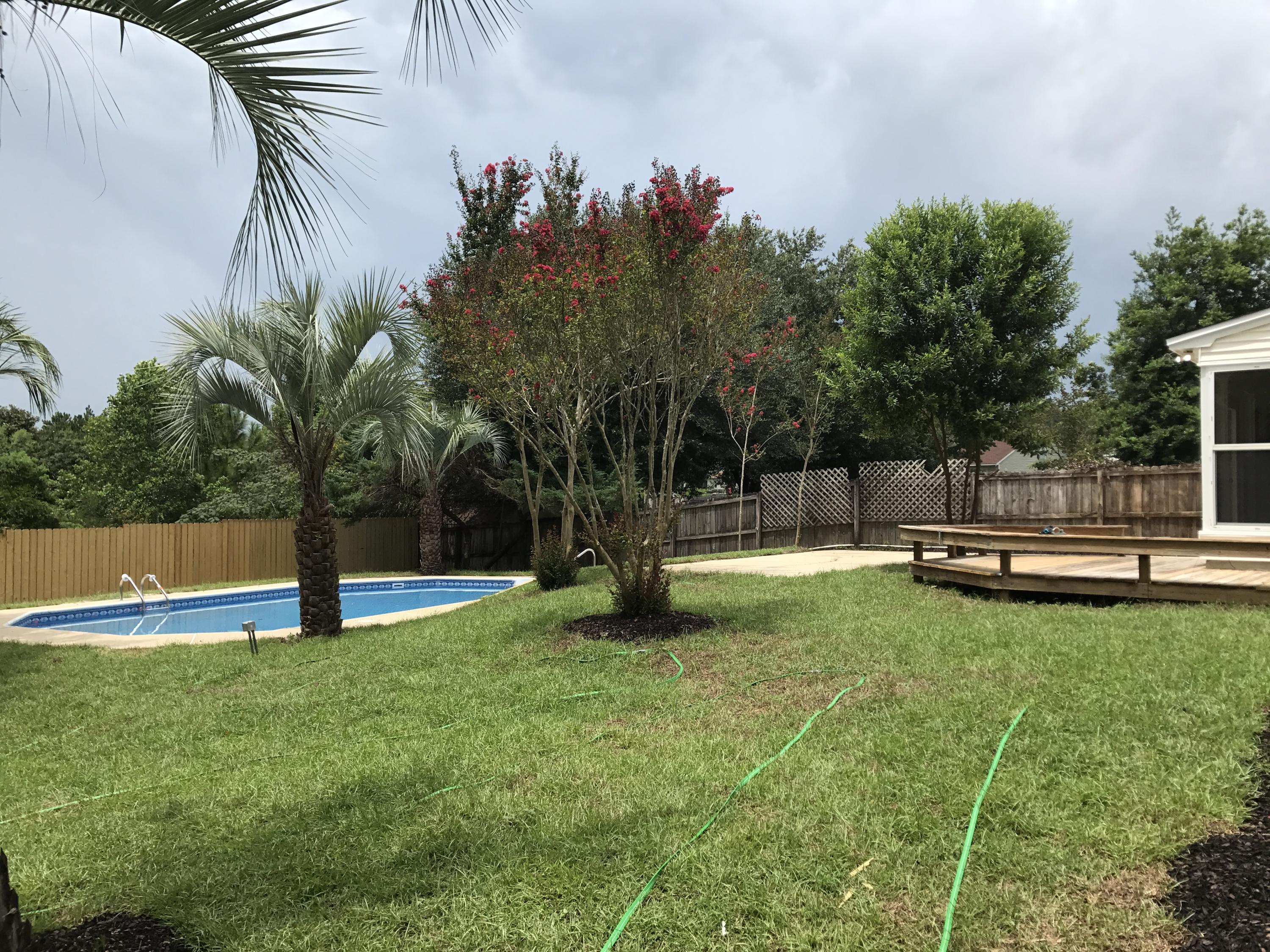 2839 Old Mill Way Crestview, FL 32539 - Photo 28 of 28 a view of a swimming pool with a garden and trees