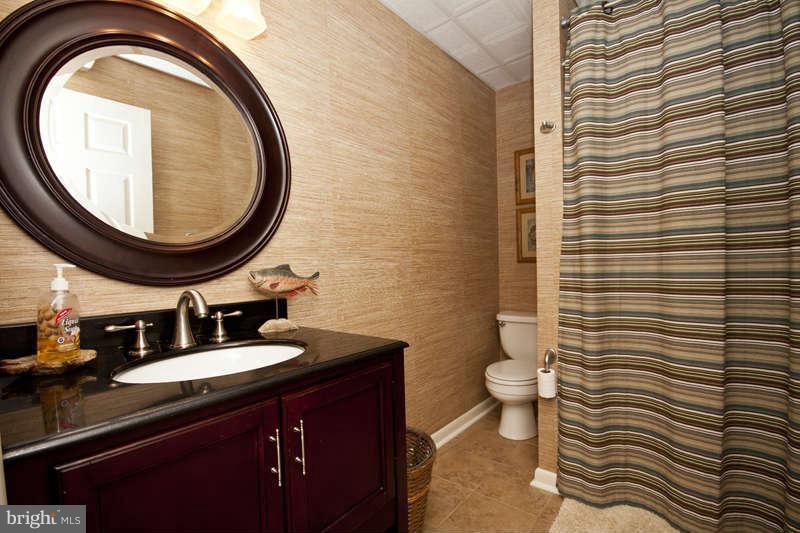 115 Houck Road Westminster, MD 21157 - Photo 25 of 30 a bathroom with a sink a toilet and a mirror