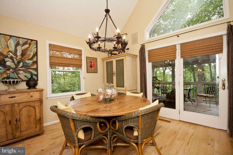 115 Houck Road Westminster, MD 21157 - Photo 4 of 30 a view of a dining room with furniture wooden floor and a chandelier