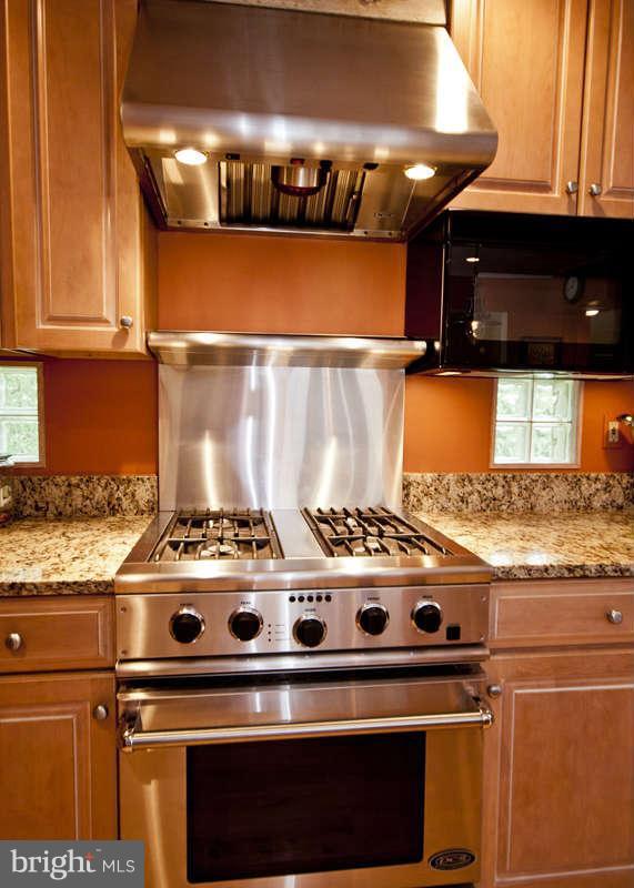 115 Houck Road Westminster, MD 21157 - Photo 10 of 30 a stove sitting inside of a kitchen with granite countertop