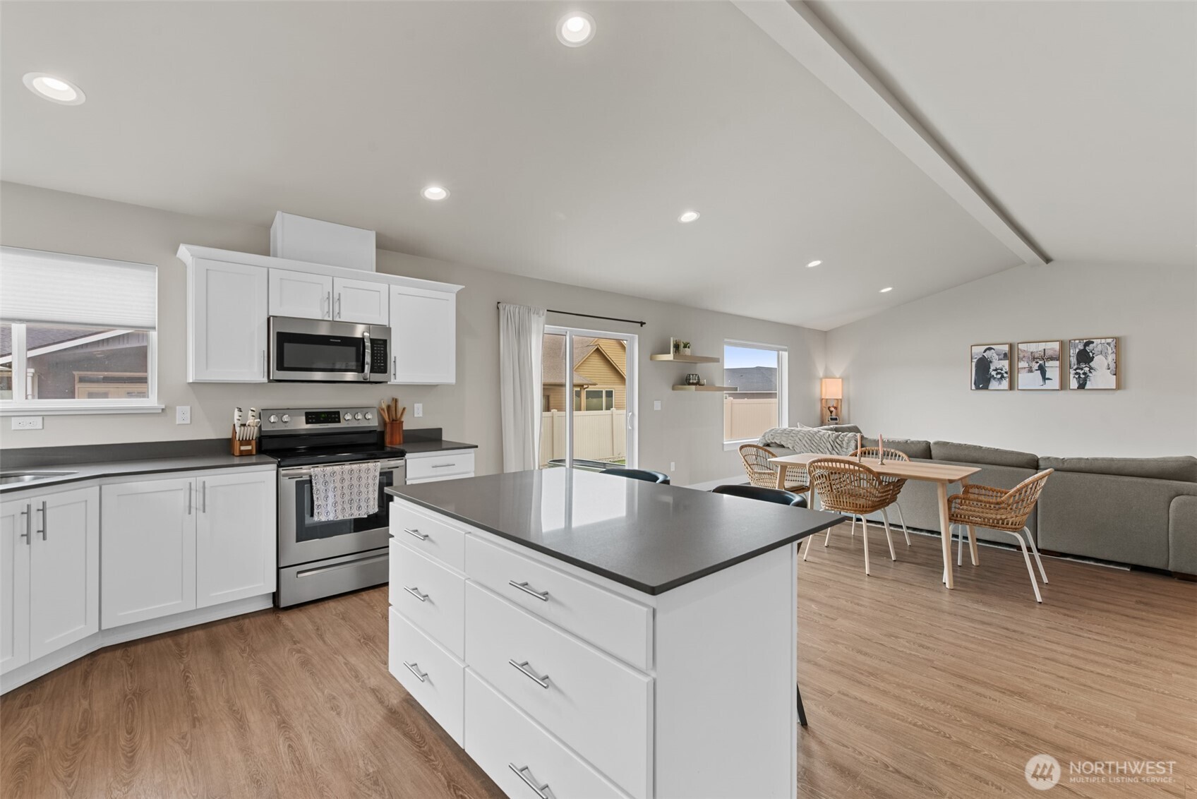 282 Emma Drive Wenatchee, WA 98801 - Photo 12 of 38 a kitchen with granite countertop a stove a sink a dining table and chairs