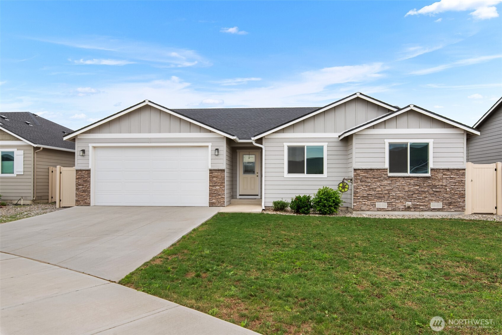 282 Emma Drive Wenatchee, WA 98801 - Photo 37 of 38 a front view of a house with a garden and yard
