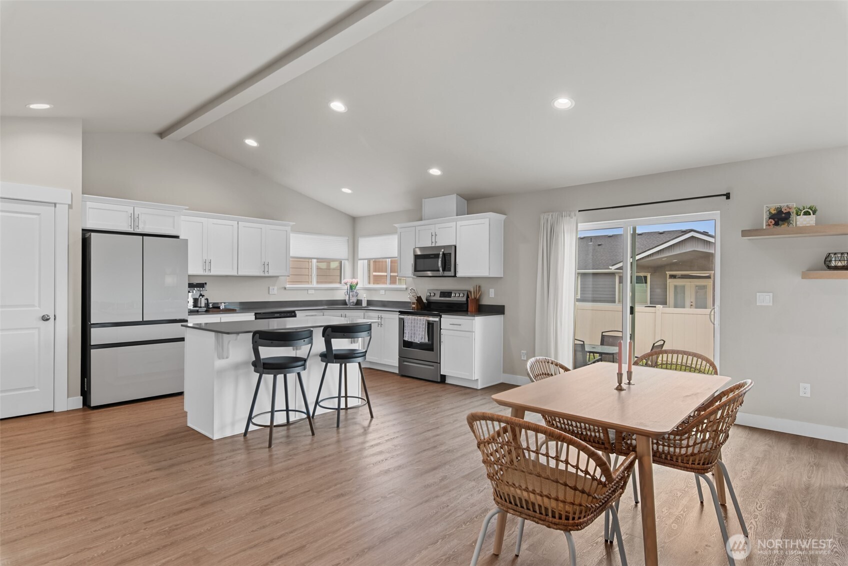 282 Emma Drive Wenatchee, WA 98801 - Photo 9 of 38 a kitchen with a dining table chairs refrigerator and microwave