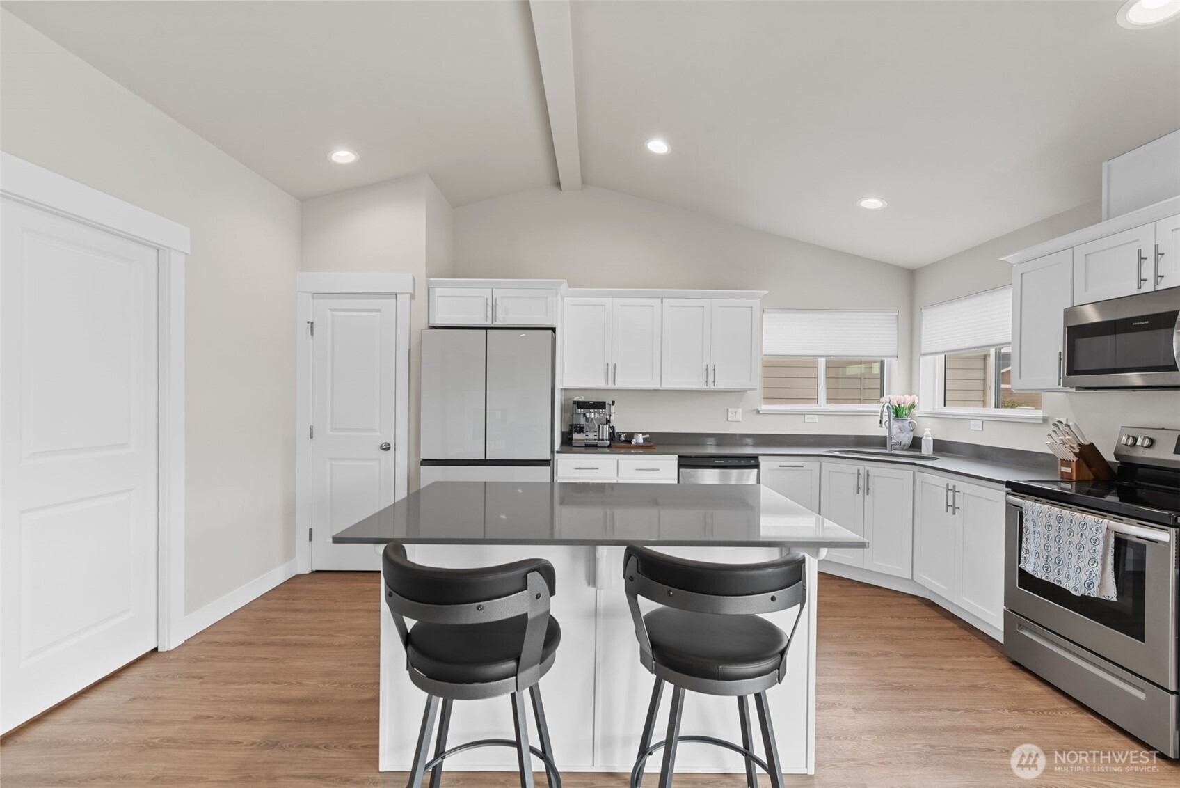 282 Emma Drive Wenatchee, WA 98801 - Photo 10 of 38 a kitchen with stainless steel appliances granite countertop a stove top oven a sink dishwasher a dining table and chairs with wooden floor