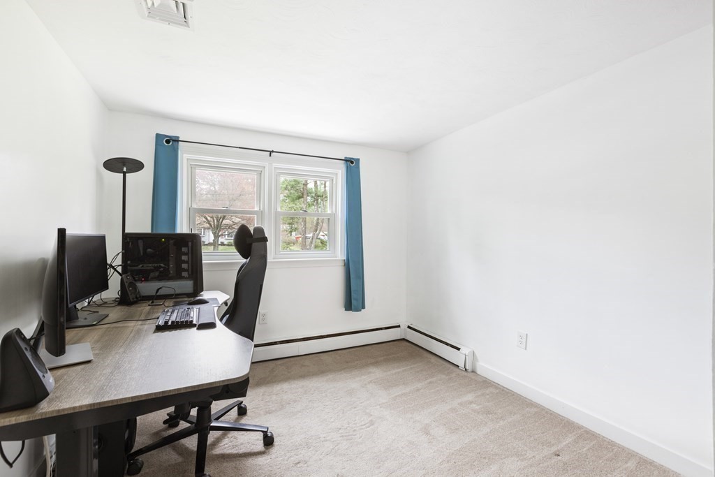 89 Richmond Road Freetown, MA 02702 - Photo 16 of 31 a view of a workspace with furniture and a window