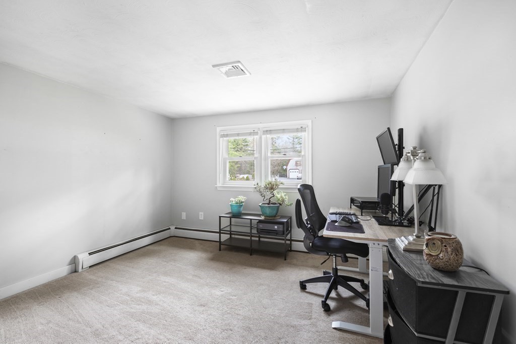 89 Richmond Road Freetown, MA 02702 - Photo 8 of 31 a view of a workspace with furniture and a window