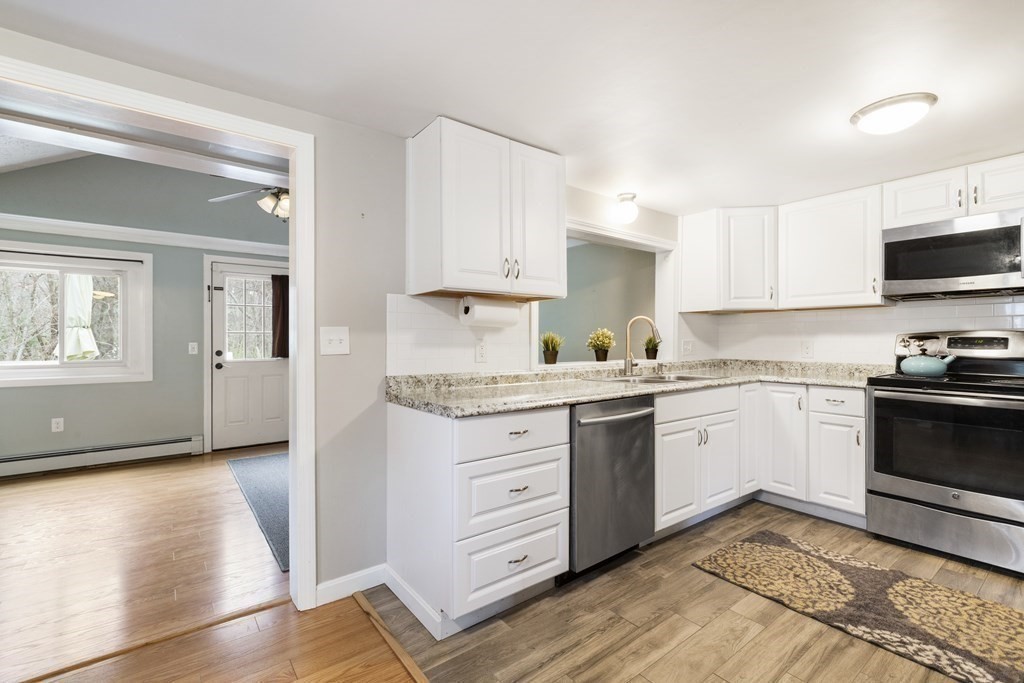 89 Richmond Road Freetown, MA 02702 - Photo 9 of 31 a kitchen with granite countertop white cabinets and white appliances