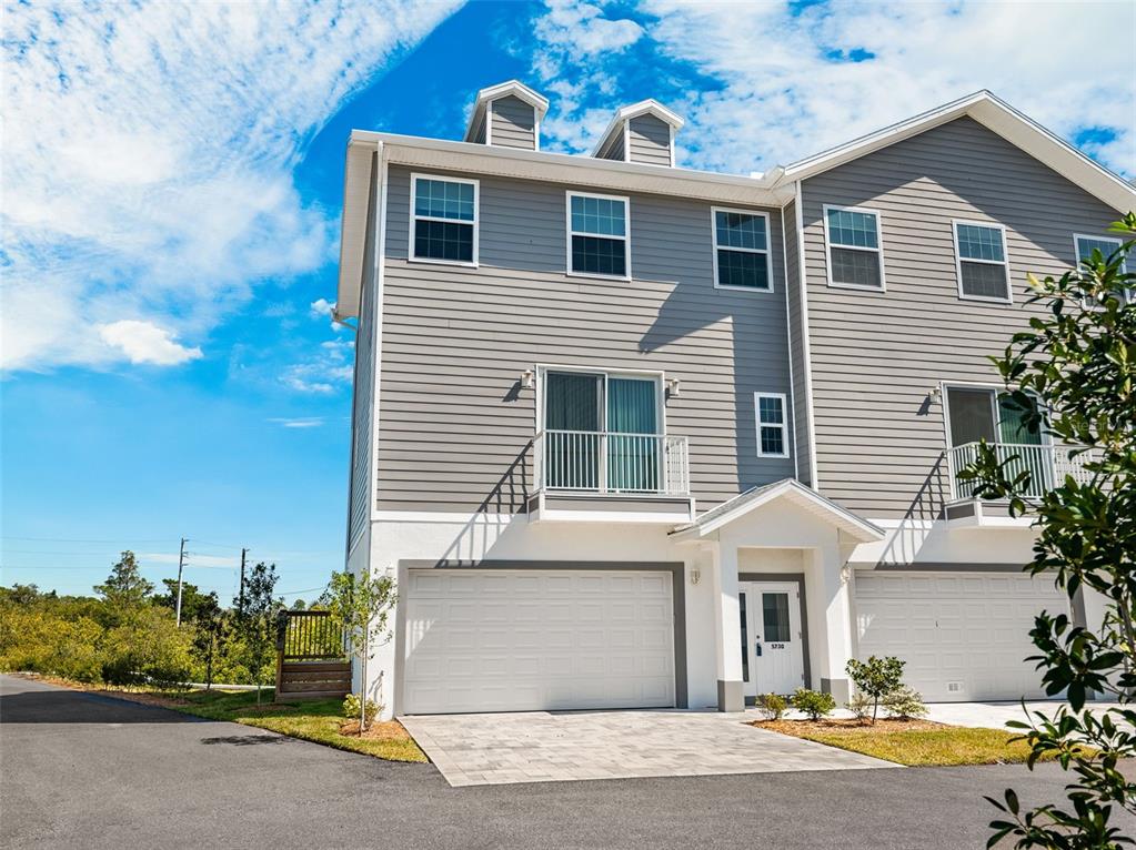 5730 Biscayne Court New Port Richey, FL 34652 - Photo 1 of 35 a front view of a house with garden