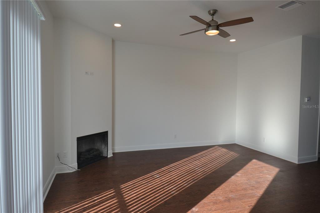 5730 Biscayne Court New Port Richey, FL 34652 - Photo 22 of 35 a bedroom with a bed and a ceiling fan