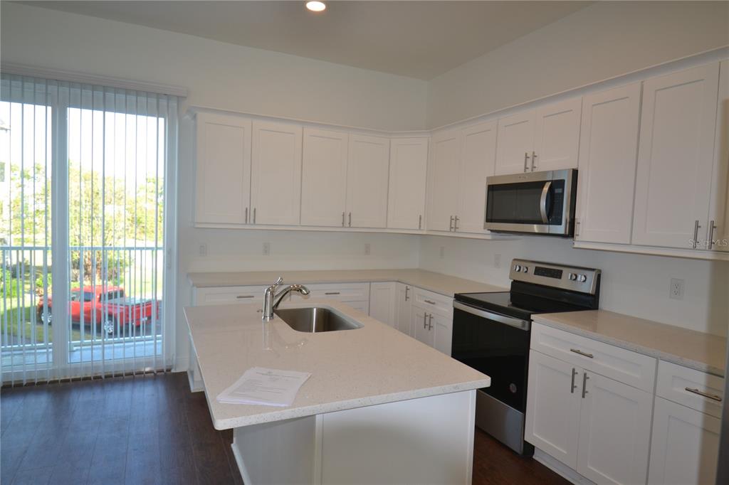 5730 Biscayne Court New Port Richey, FL 34652 - Photo 24 of 35 a kitchen with a sink and a stove top oven