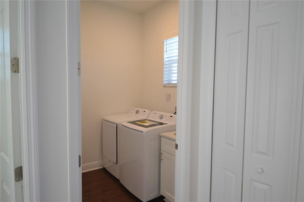 5730 Biscayne Court New Port Richey, FL 34652 - Photo 25 of 35 a view of a utility room with washer and dryer