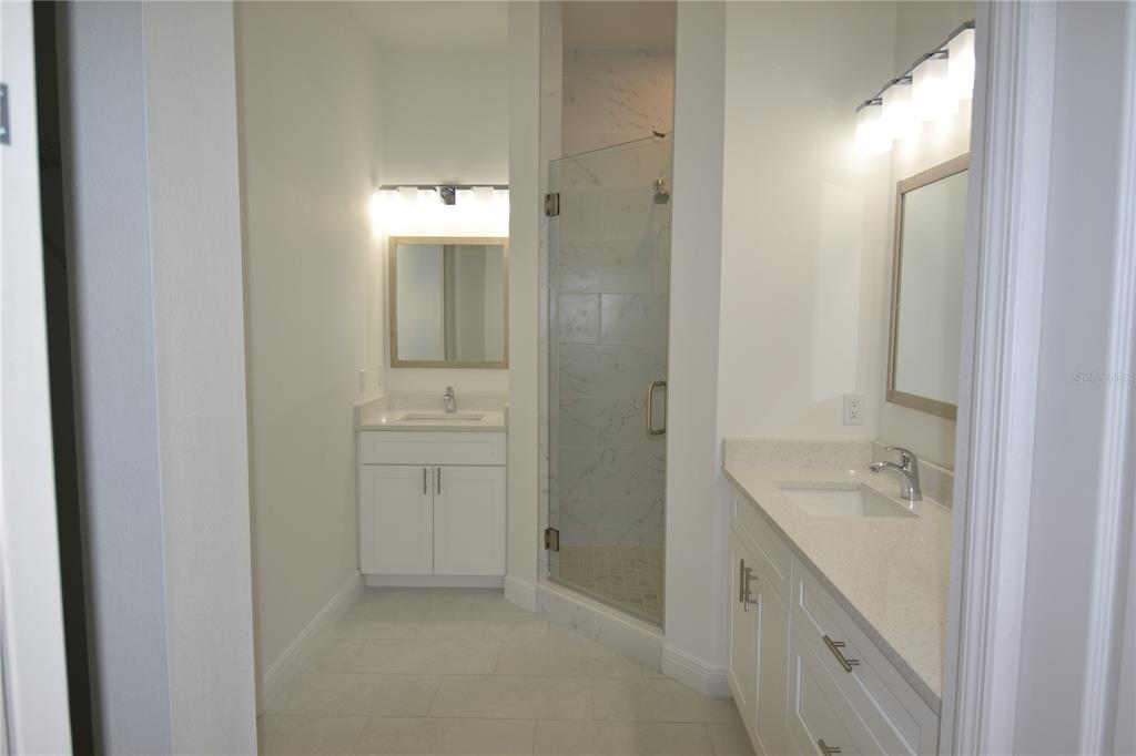 5730 Biscayne Court New Port Richey, FL 34652 - Photo 29 of 35 a bathroom with a bathtub sink double and mirror