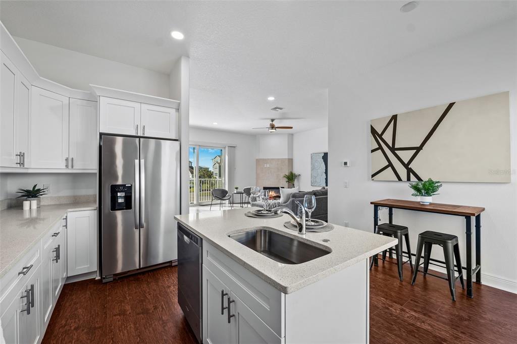 5730 Biscayne Court New Port Richey, FL 34652 - Photo 5 of 35 a kitchen with a sink a kitchen island stainless steel appliances cabinets and wooden floor