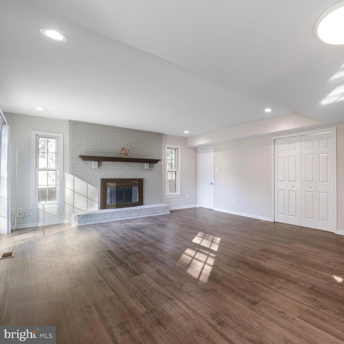 13802 Poplar Tree Road Chantilly, VA 20151 - Photo 21 of 61 a view of empty room with wooden floor and fireplace