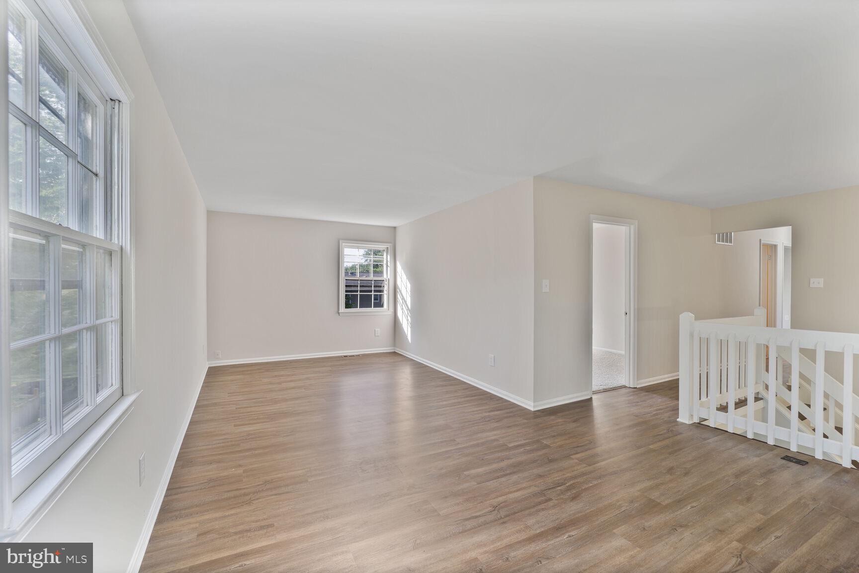 13802 Poplar Tree Road Chantilly, VA 20151 - Photo 28 of 61 a view of an empty room with wooden floor and a window