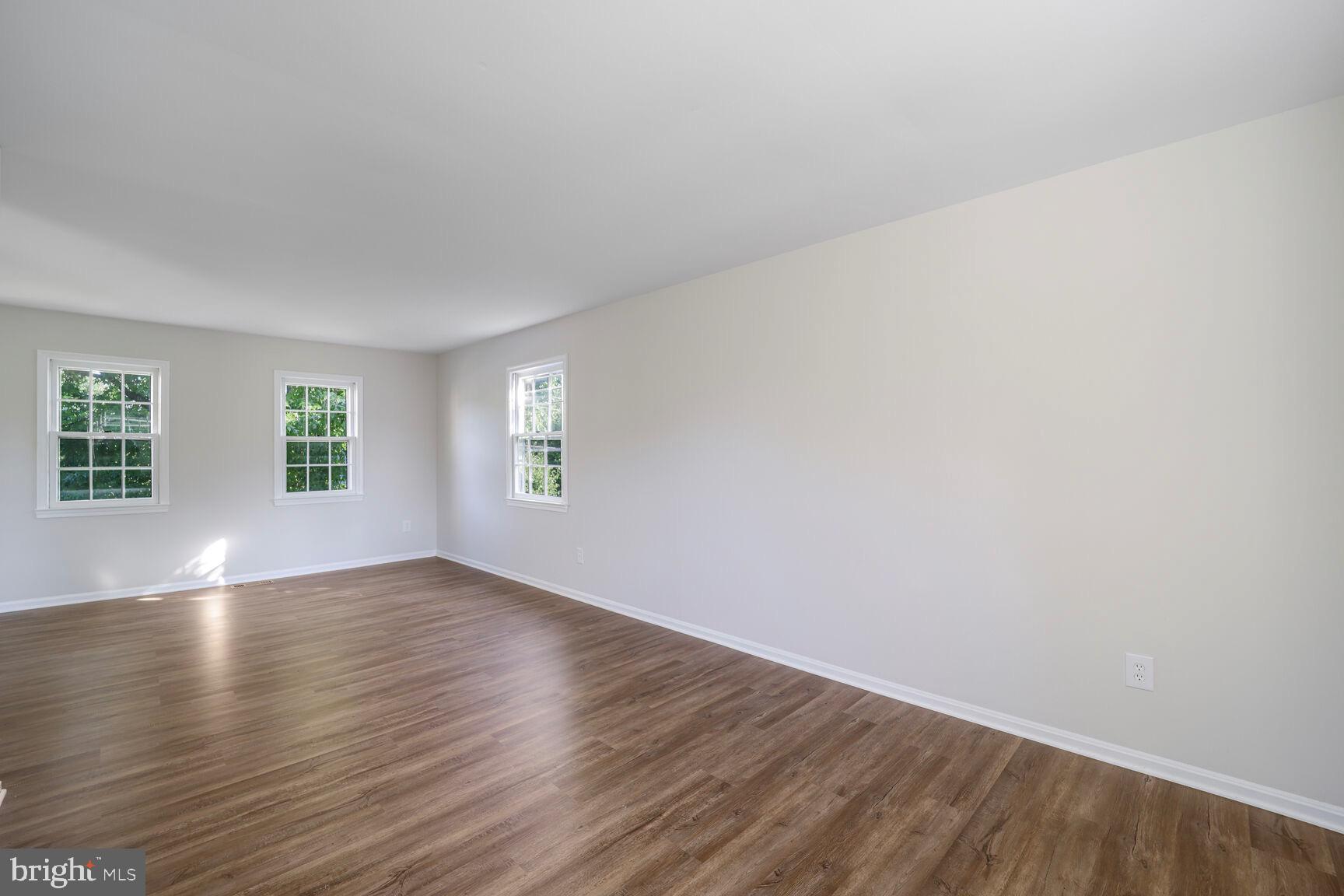 13802 Poplar Tree Road Chantilly, VA 20151 - Photo 30 of 61 an empty room with wooden floor and windows