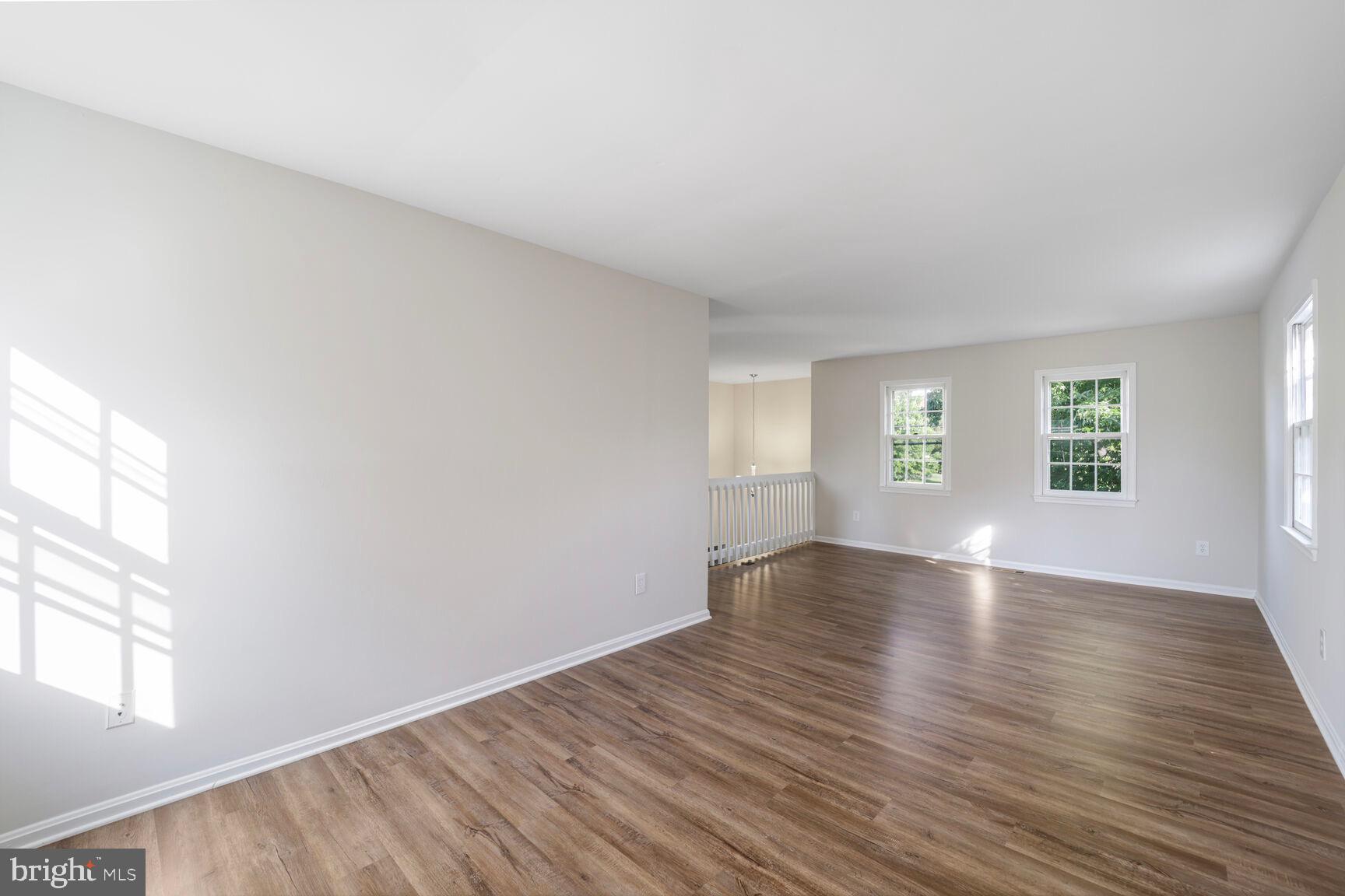 13802 Poplar Tree Road Chantilly, VA 20151 - Photo 31 of 61 an empty room with wooden floor and windows