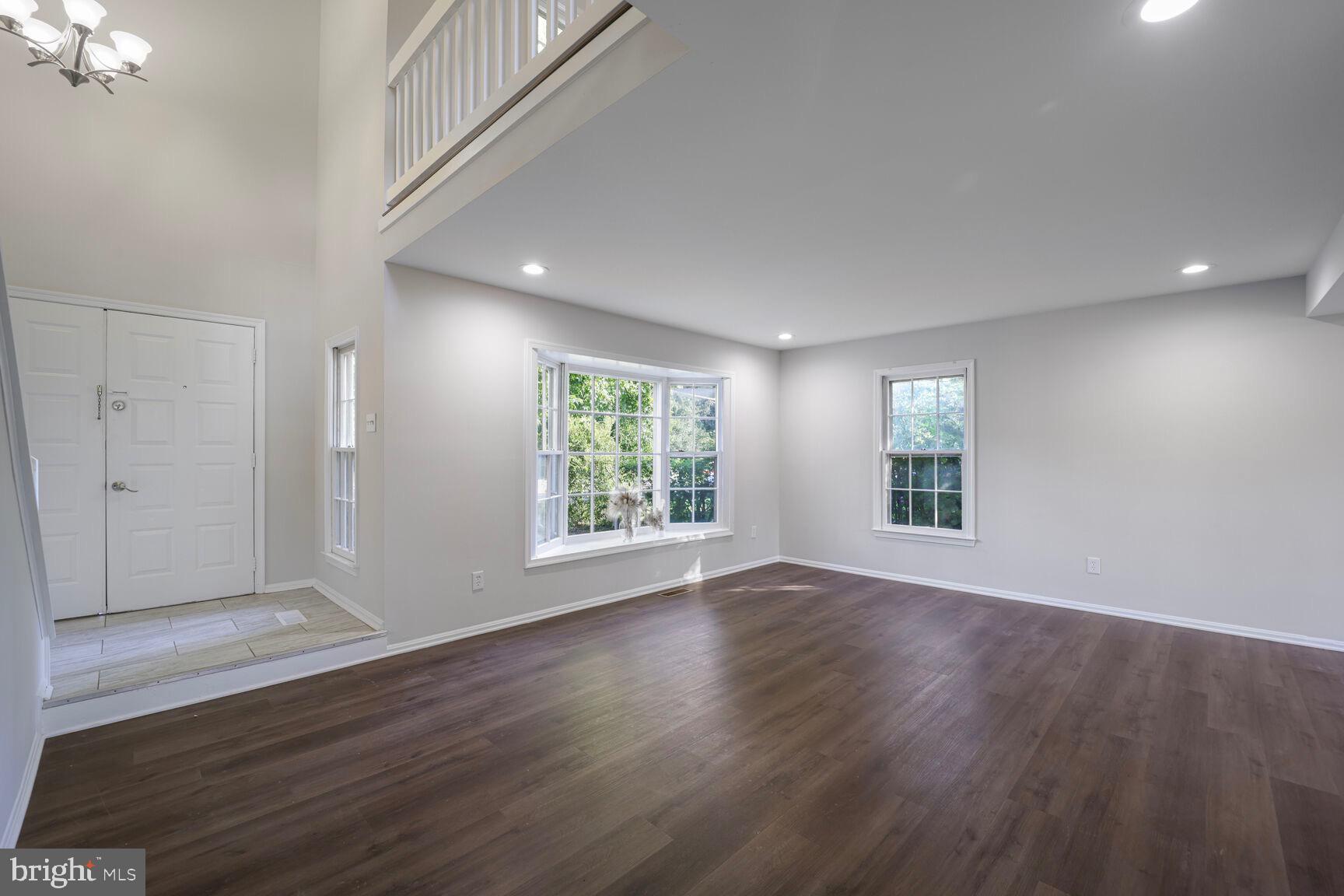 13802 Poplar Tree Road Chantilly, VA 20151 - Photo 4 of 61 a view of an empty room with wooden floor and a window
