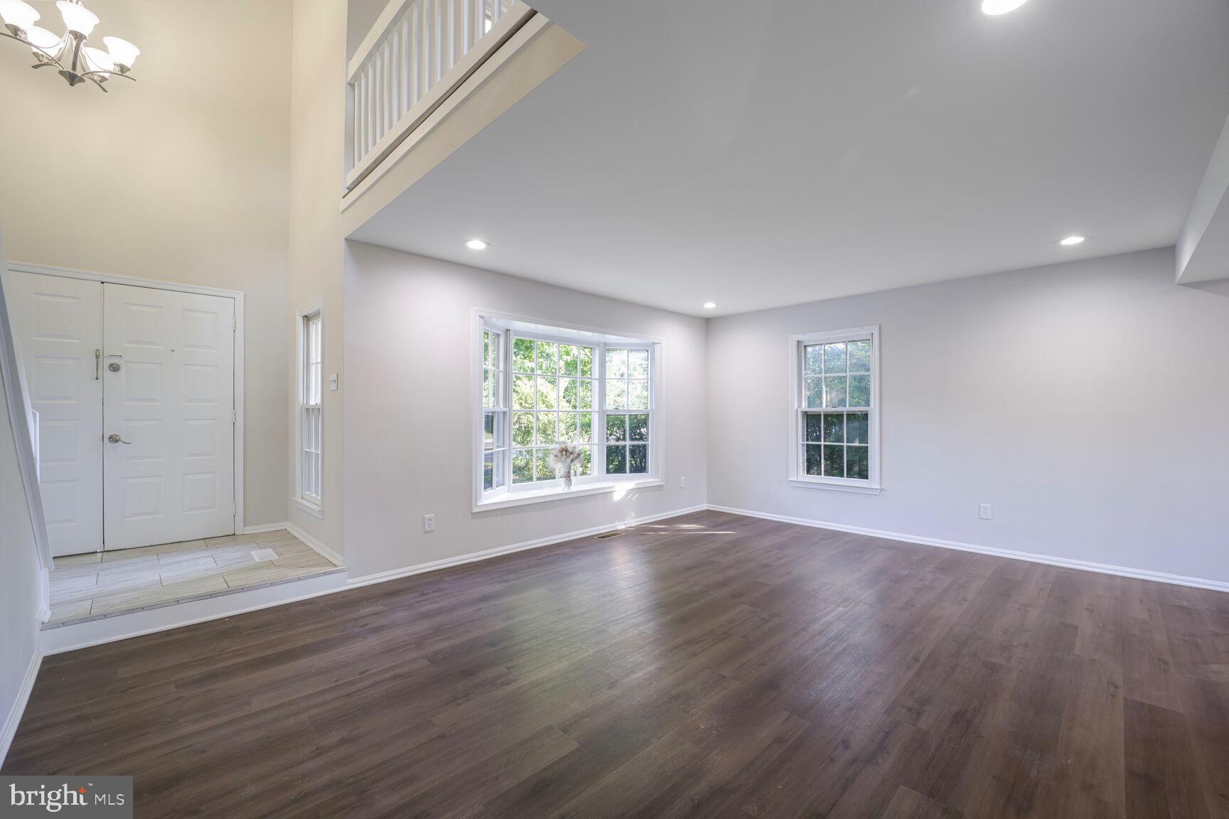 13802 Poplar Tree Road Chantilly, VA 20151 - Photo 6 of 61 a view of an empty room with wooden floor and a window