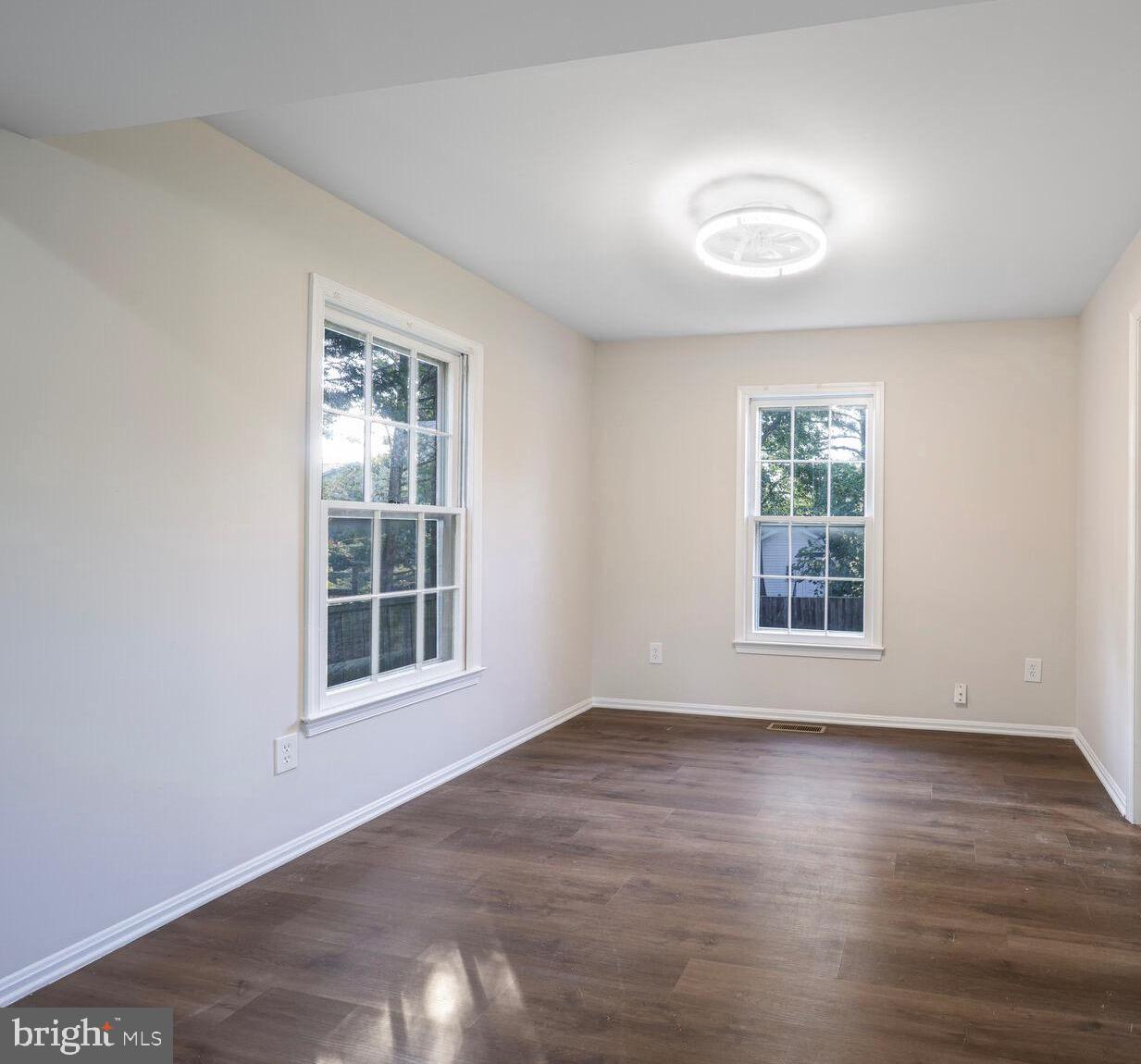 13802 Poplar Tree Road Chantilly, VA 20151 - Photo 8 of 61 an empty room with wooden floor and windows