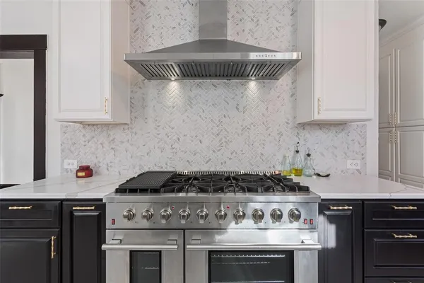a stove top oven sitting inside of a kitchen