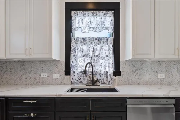 a kitchen with a sink and cabinets