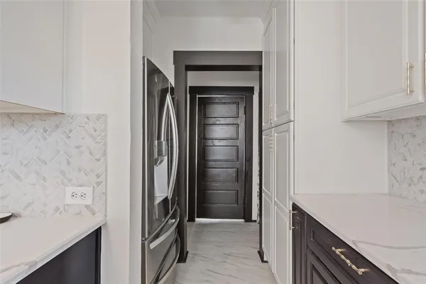 a kitchen with a sink and refrigerator