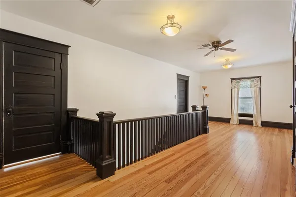 a view of a room with wooden floor