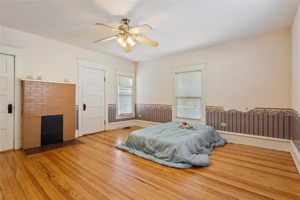 a bedroom with a bed and a chandelier