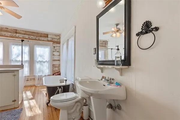 a bathroom with a sink toilet a mirror and tub