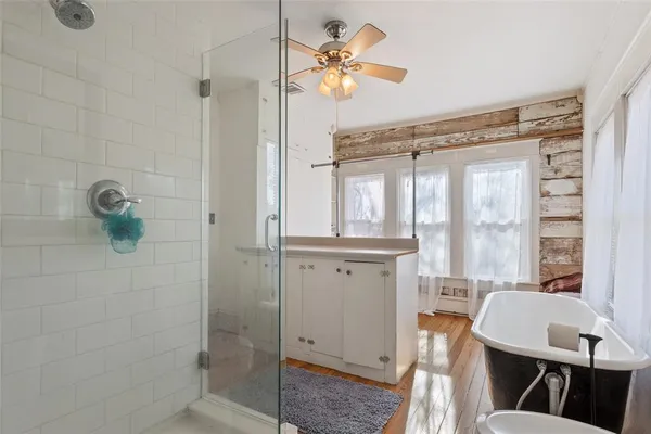a bathroom with a granite countertop sink a toilet and shower