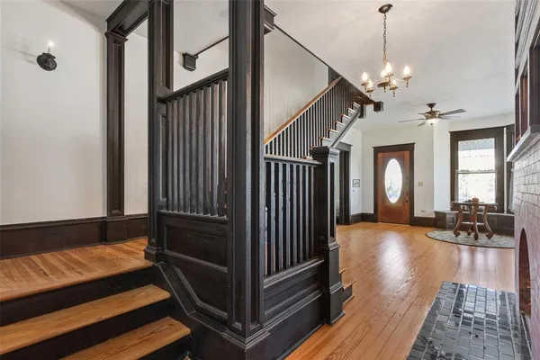 a view of a livingroom with hardwood floor and staircase