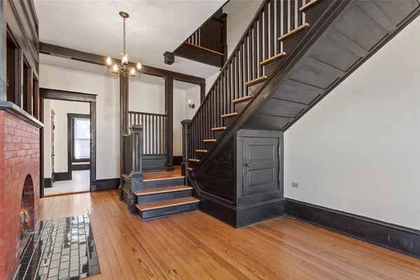 a view of entryway and hall with wooden floor