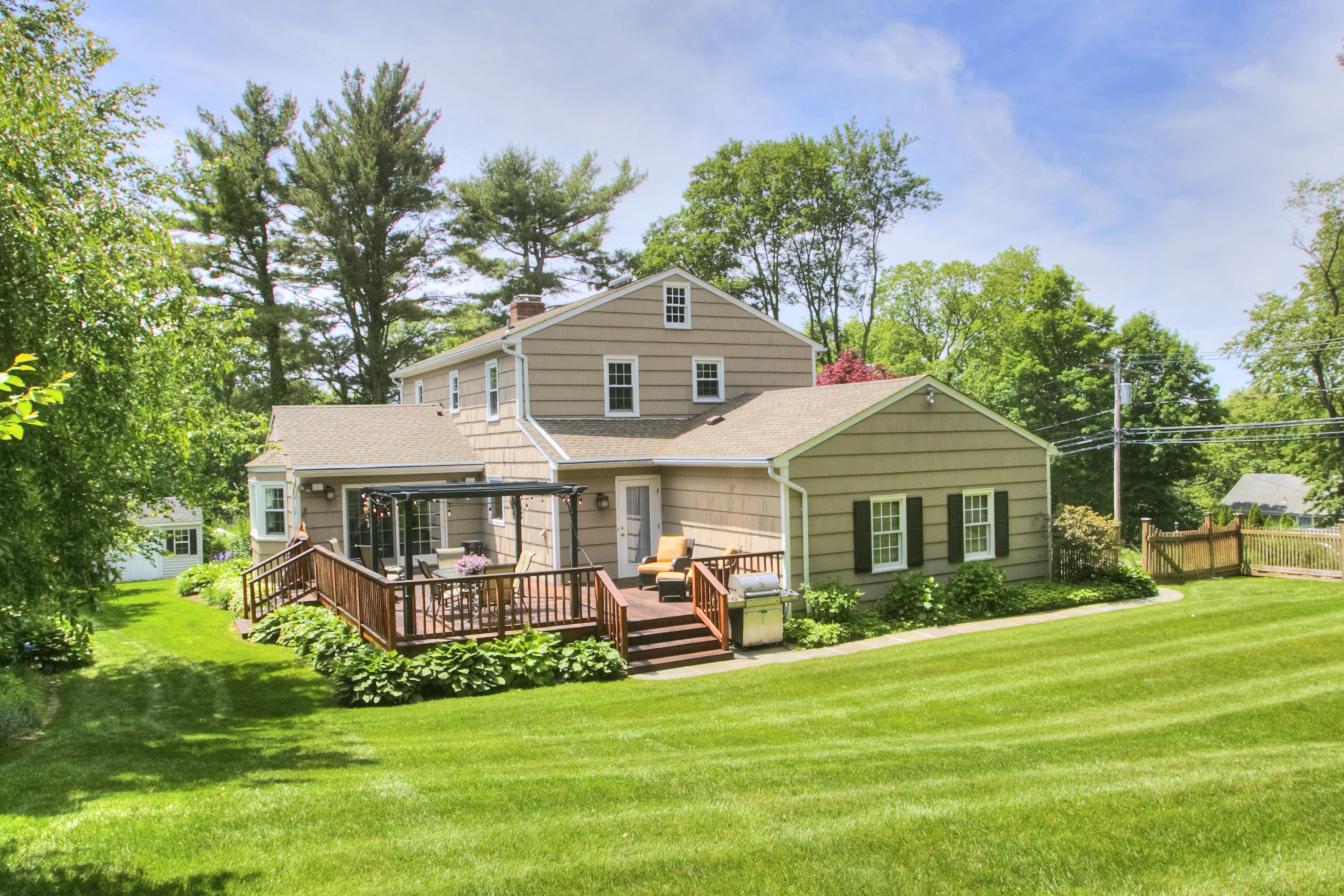 20 Hollow Tree Ridge Road Darien, CT 06820 - Photo 2 of 25 a front view of a house with a yard table and chairs