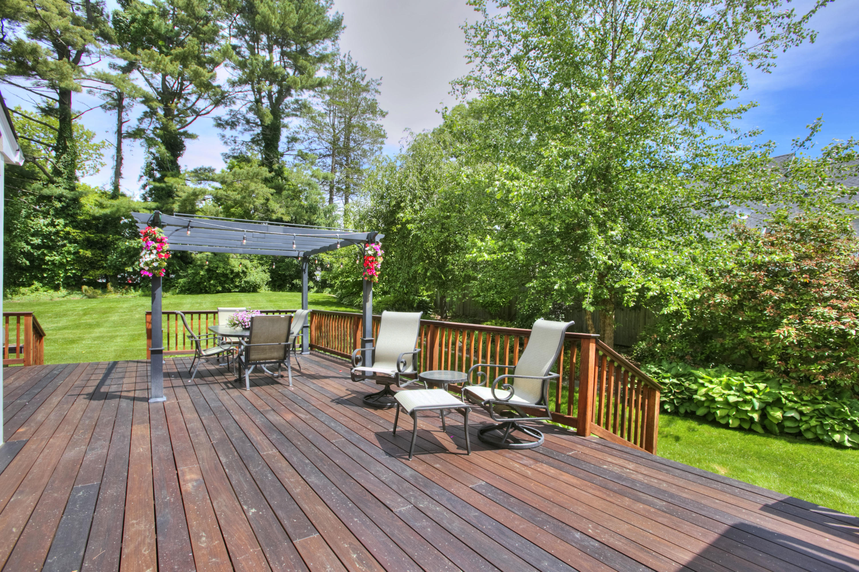 20 Hollow Tree Ridge Road Darien, CT 06820 - Photo 4 of 25 a view of a chairs and table on the wooden deck