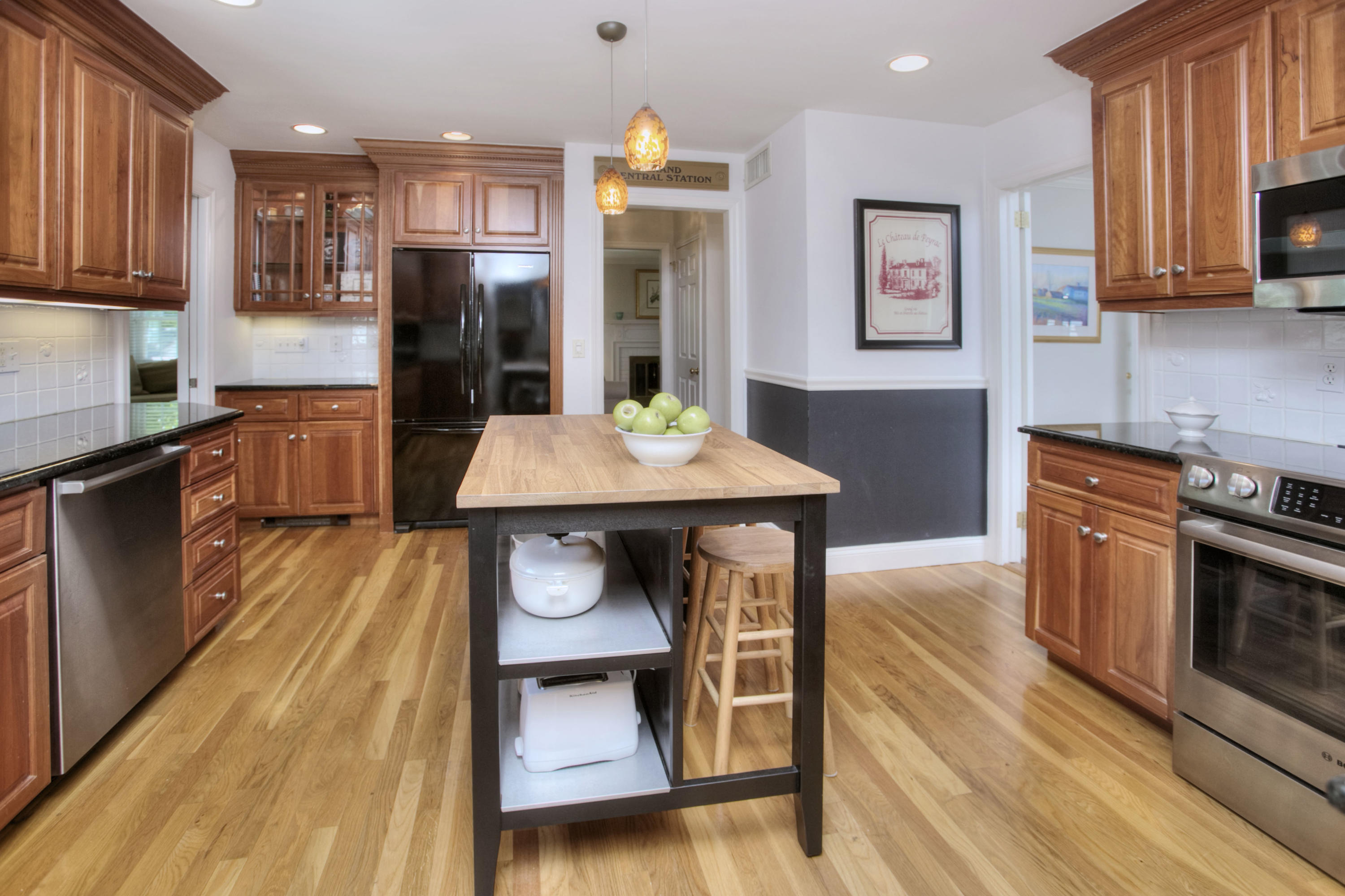 20 Hollow Tree Ridge Road Darien, CT 06820 - Photo 8 of 25 a kitchen with stainless steel appliances wooden floor dining table and chairs
