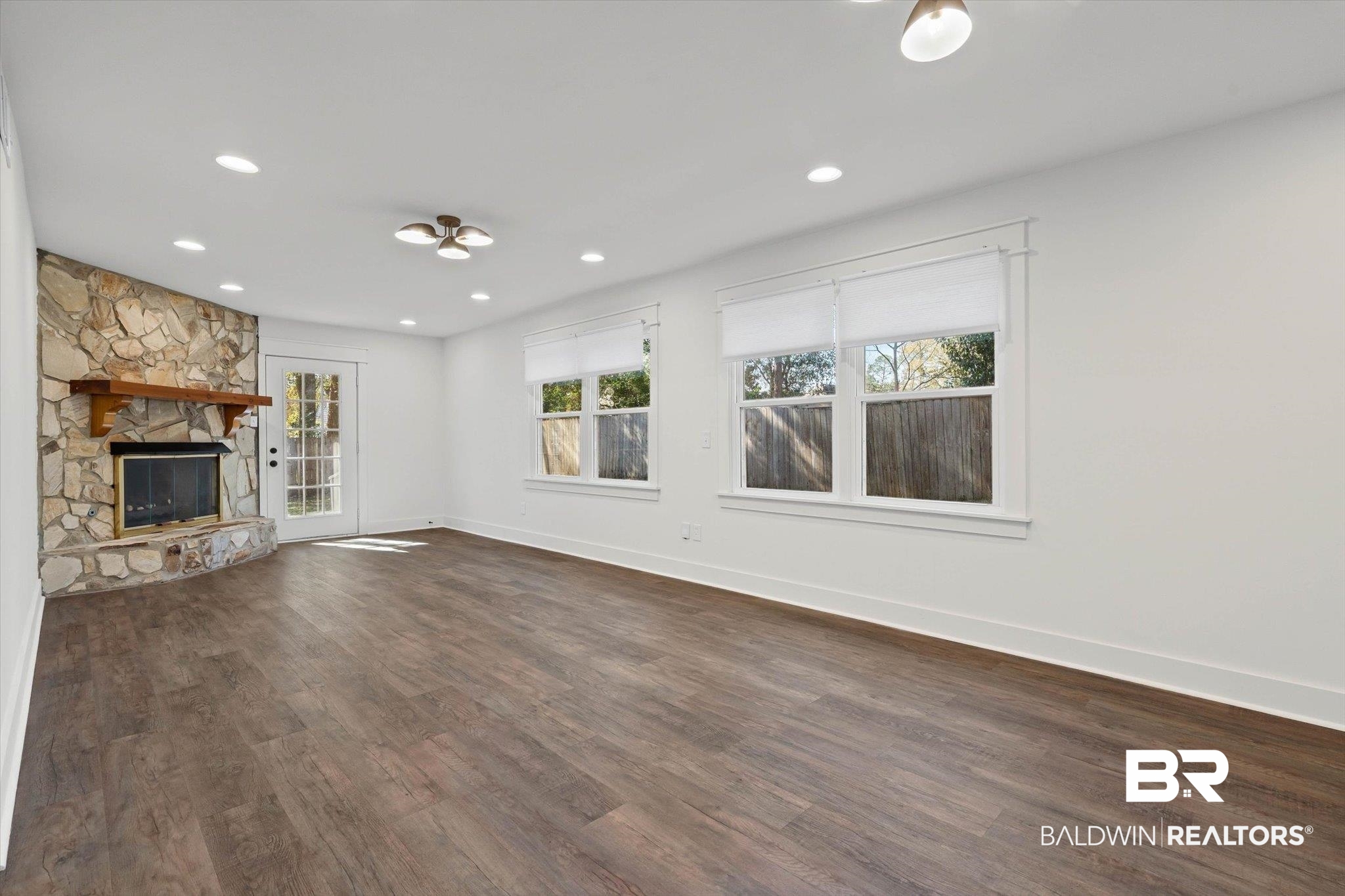 3933 Radnor Avenue Mobile, AL 36608 - Photo 3 of 36 Natural light, a fireplace, dark wood finished floors, and recessed lighting add to this impressive space ...