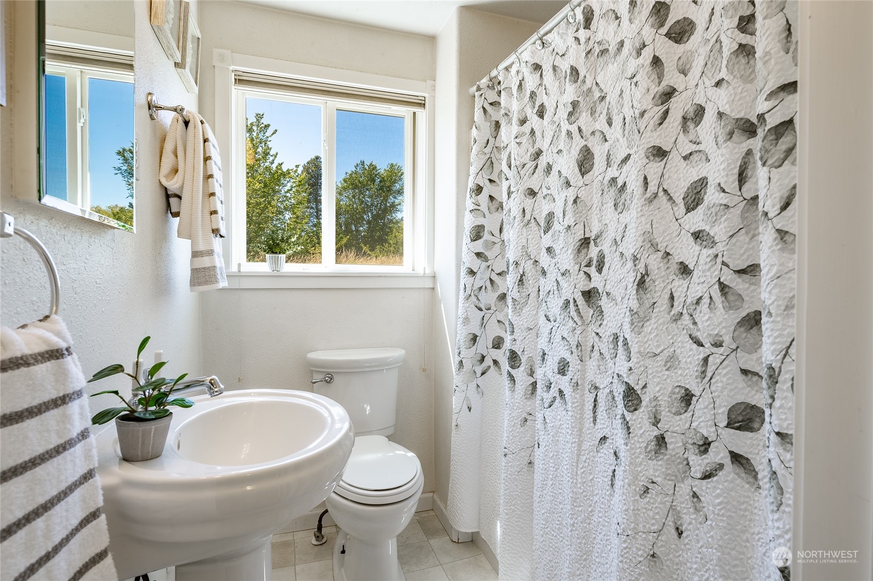 680 East Smith Road Bellingham, WA 98226 - Photo 16 of 32 a white toilet sitting next to a shower curtain