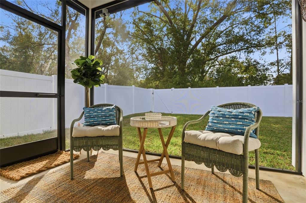 1012 Farmstead Street Eustis, FL 32736 - Photo 13 of 28 a patio table and chairs with potted plants