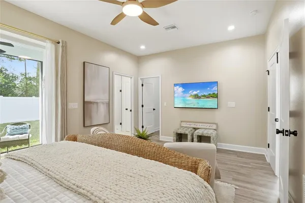 a bedroom with a bed and a flat screen tv