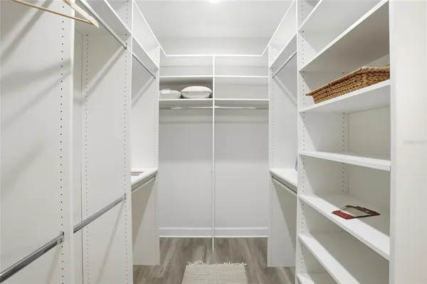 a view of walk in closet with empty racks