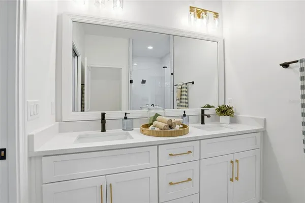 a bathroom with double sink and a mirror