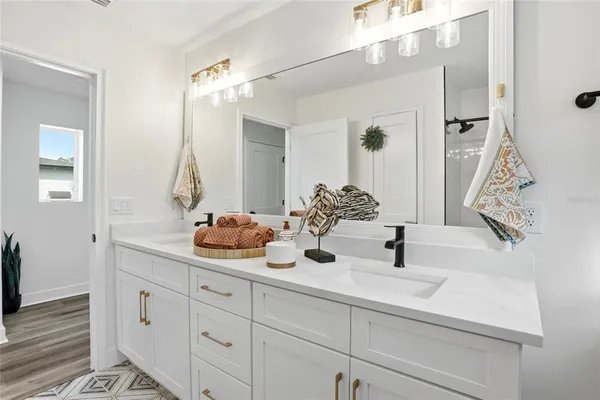 a bathroom with a double vanity sink and a mirror
