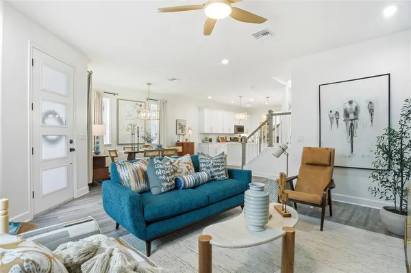a living room with furniture and wooden floor