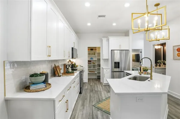 a kitchen with sink a counter and cabinets