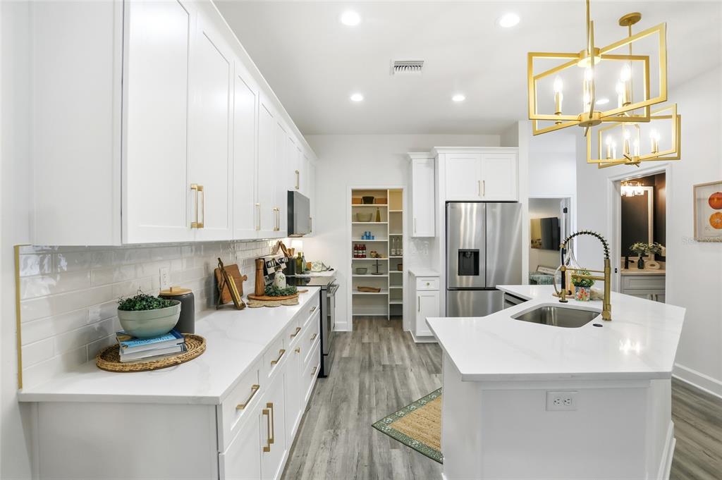 1012 Farmstead Street Eustis, FL 32736 - Photo 7 of 28 a kitchen with sink a counter and cabinets