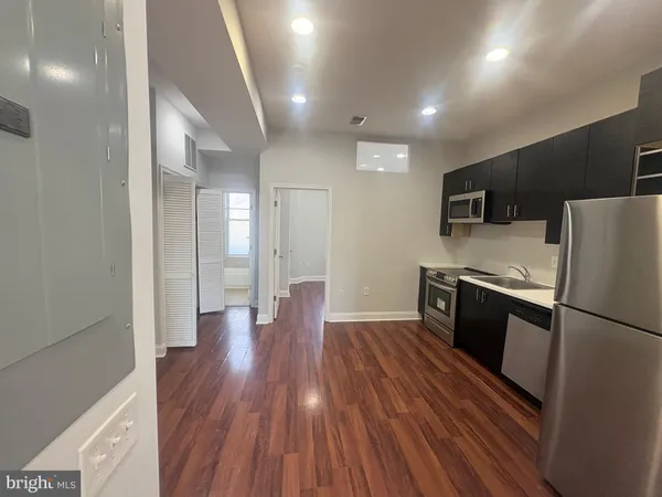 a kitchen with a refrigerator and a stove top oven