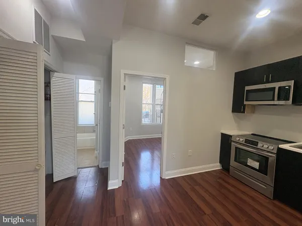 a view of kitchen with furniture and wooden floor