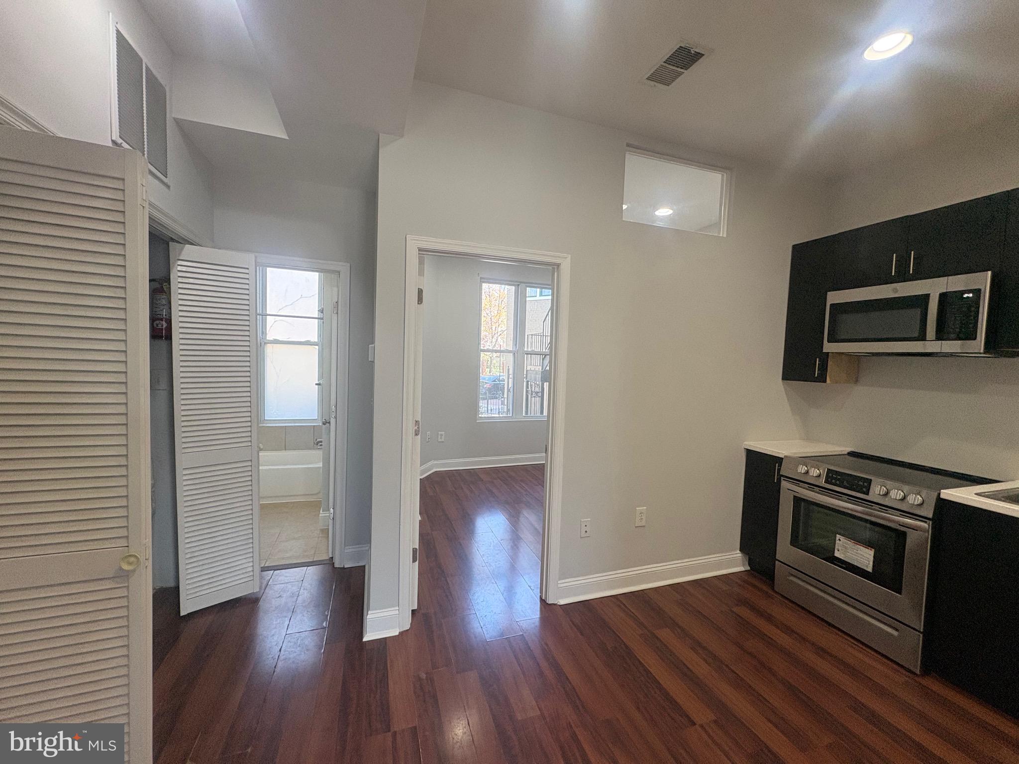 543 Florida Avenue Northwest, Unit 2 Washington, DC 20001 - Photo 5 of 11 a view of kitchen with furniture and wooden floor