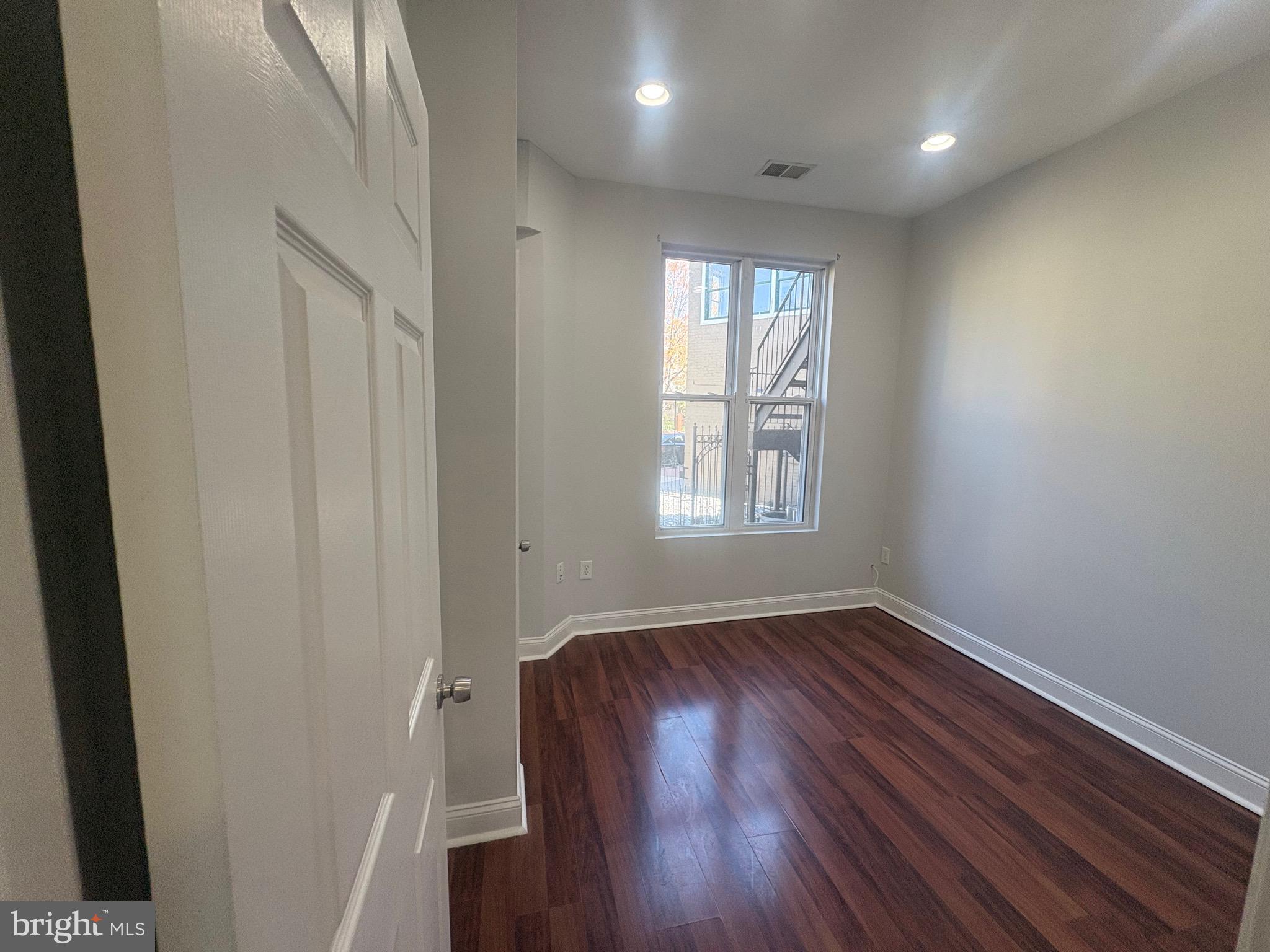 543 Florida Avenue Northwest, Unit 2 Washington, DC 20001 - Photo 7 of 11 a view of an empty room with wooden floor and a window